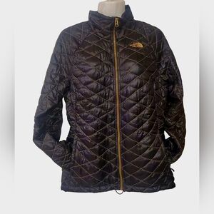 The North Face Quilted Puffer Jacket in Black with Gold Accents
